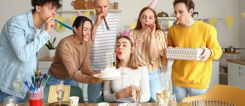 Friends celebrate a birthday together while exploring what age does car insurance get cheaper.