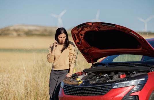 Displeased young adult woman breaks down car in the middle of trip on the road, needs a car safety kit, calls tow truck to come repair car, roadside assistance, broken down car.