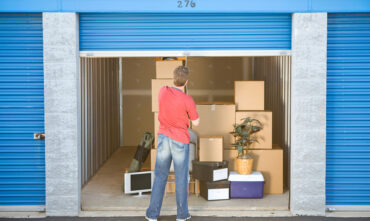 man shutting door on storage unit