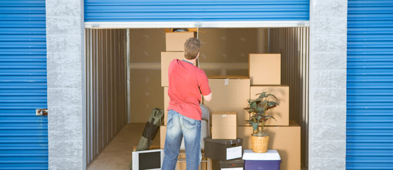 man shutting door on storage unit