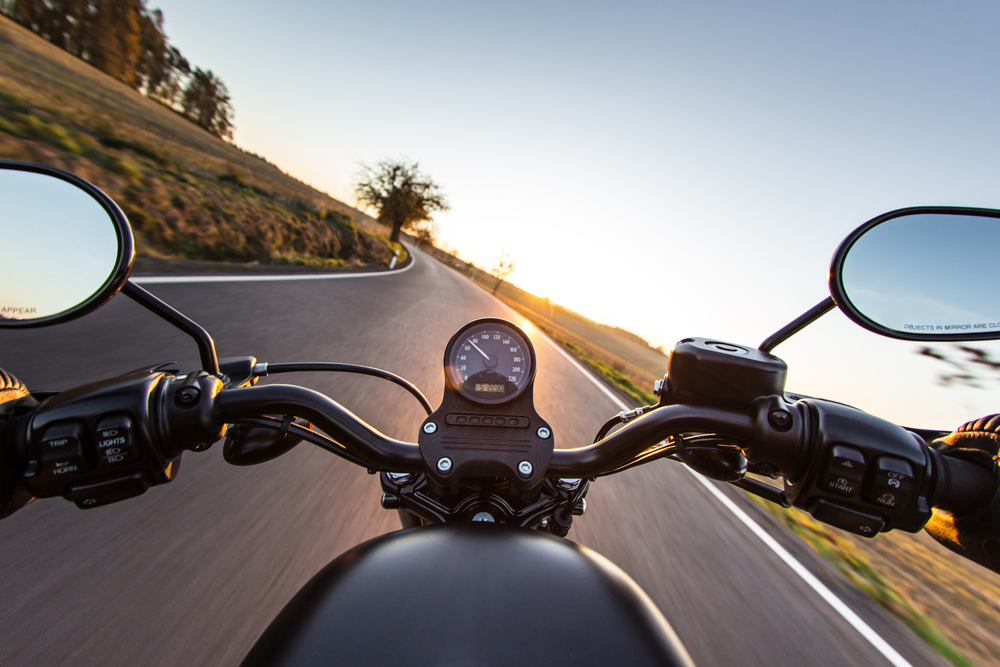 handlebars of motorcycle driving down highway