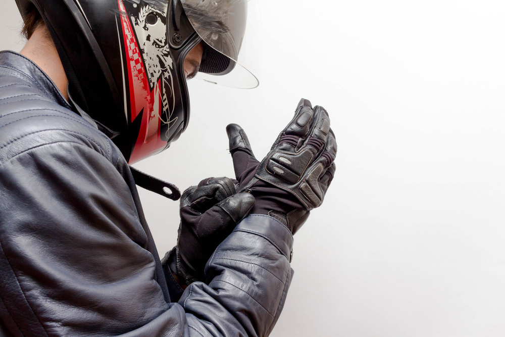 motorcycle biker gearing up with gloves and helmet