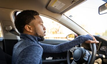 african american man driving car