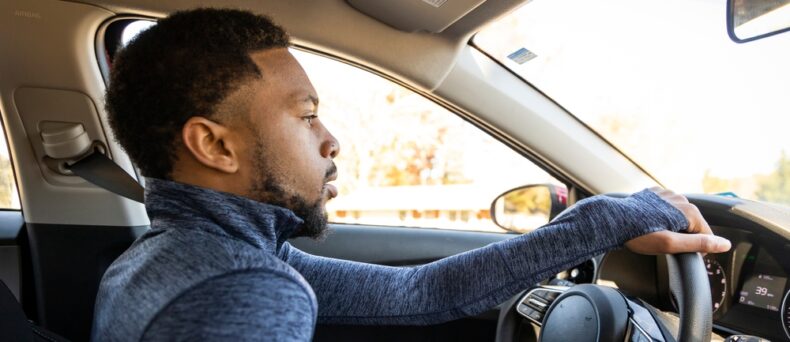 african american man driving car