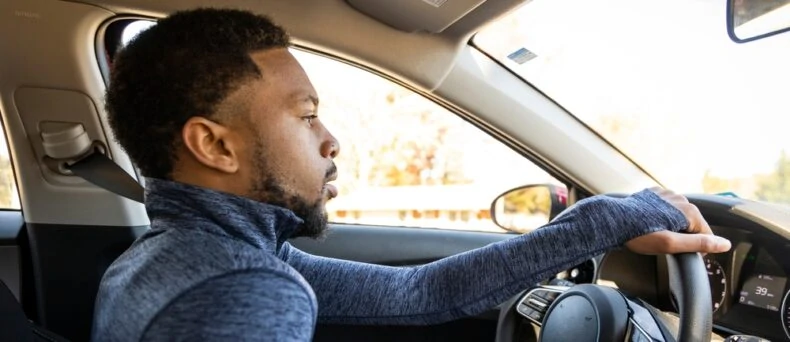 african american man driving car