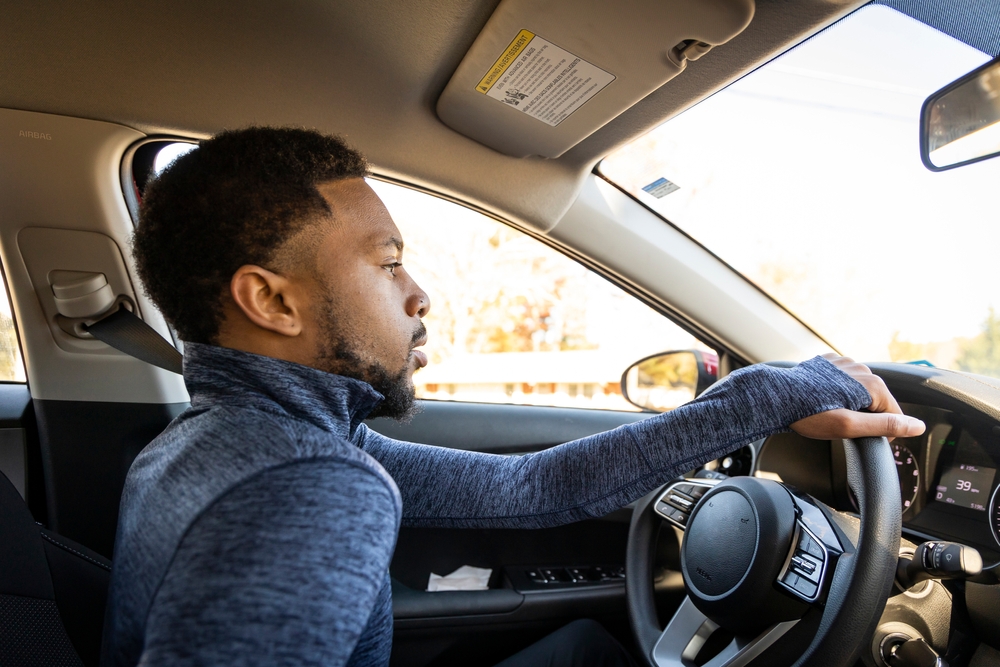 african american man driving car