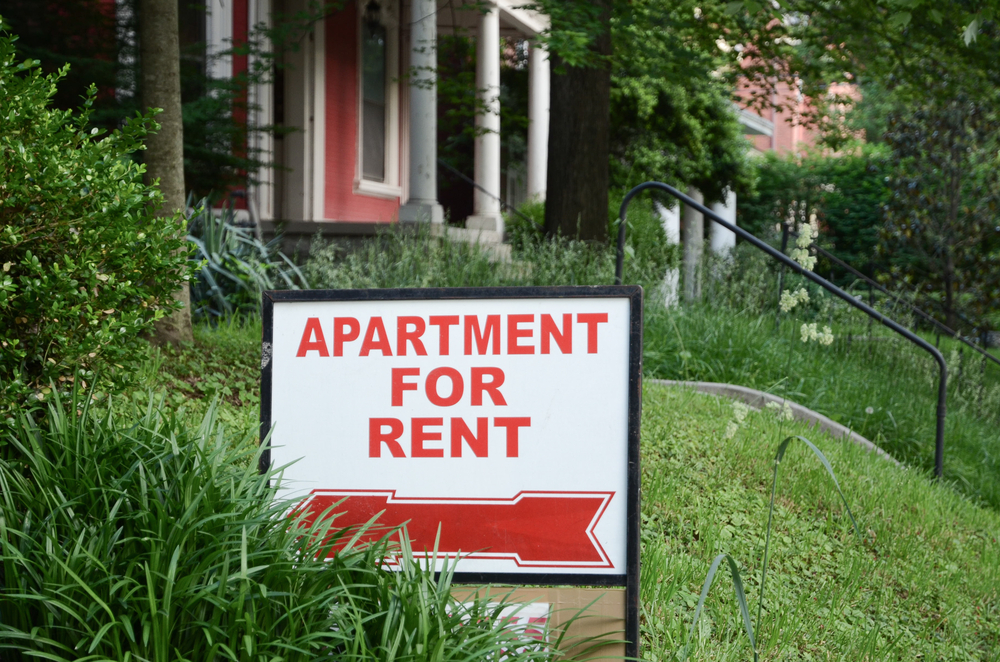 for rent sign outside apartment building