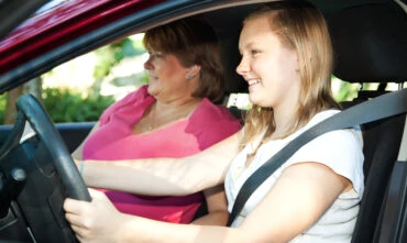 caucasian mother and daughter learning to drive