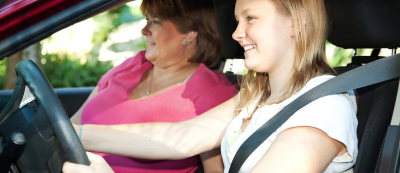 caucasian mother and daughter learning to drive