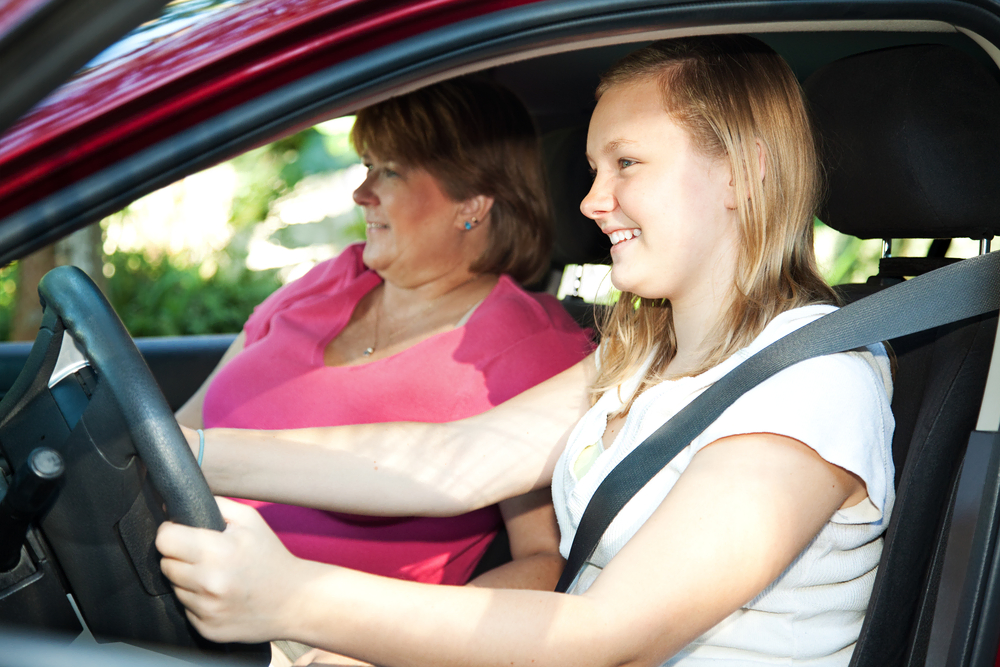 caucasian mother and daughter learning to drive