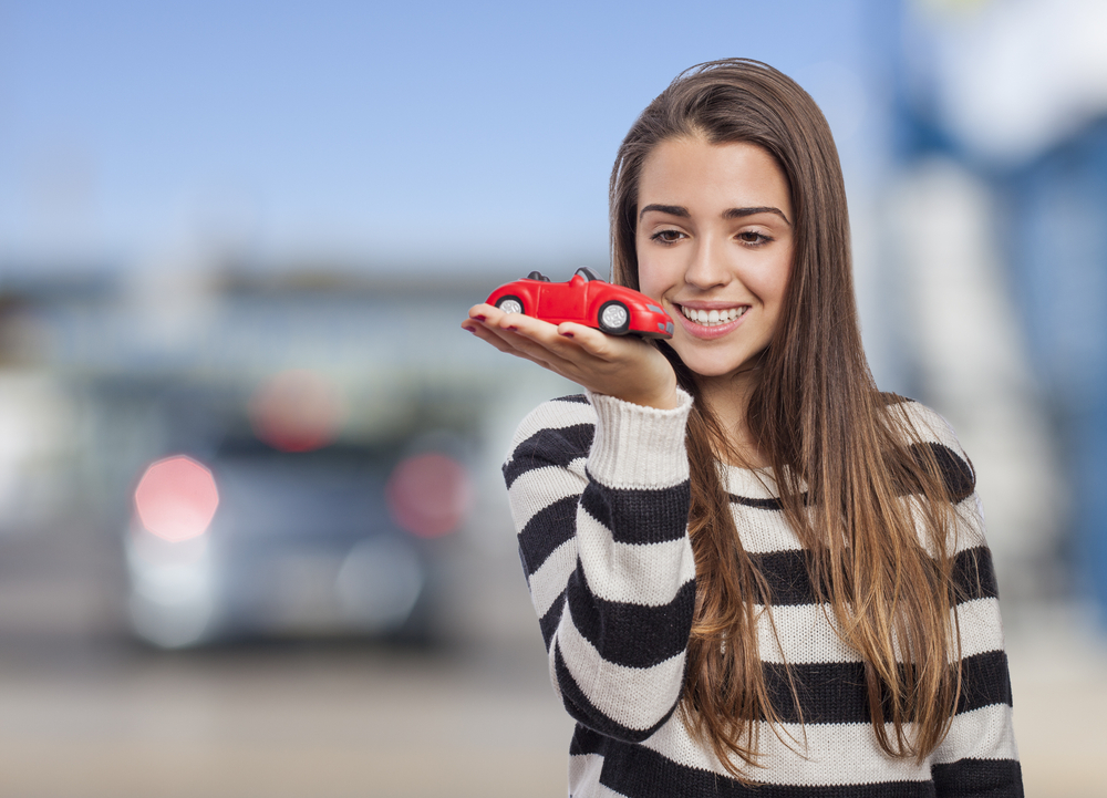 woman holding toy car