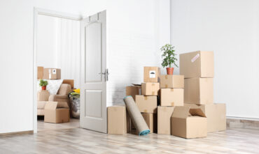 apartment with boxes in middle of room
