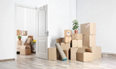 apartment with boxes in middle of room