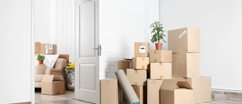 apartment with boxes in middle of room