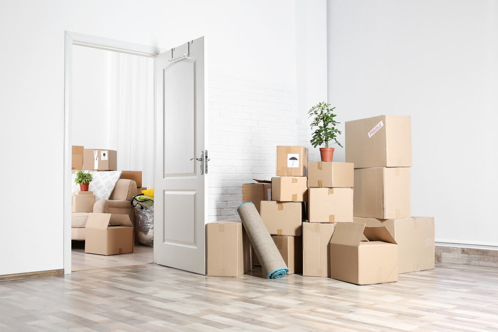 apartment with boxes in middle of room