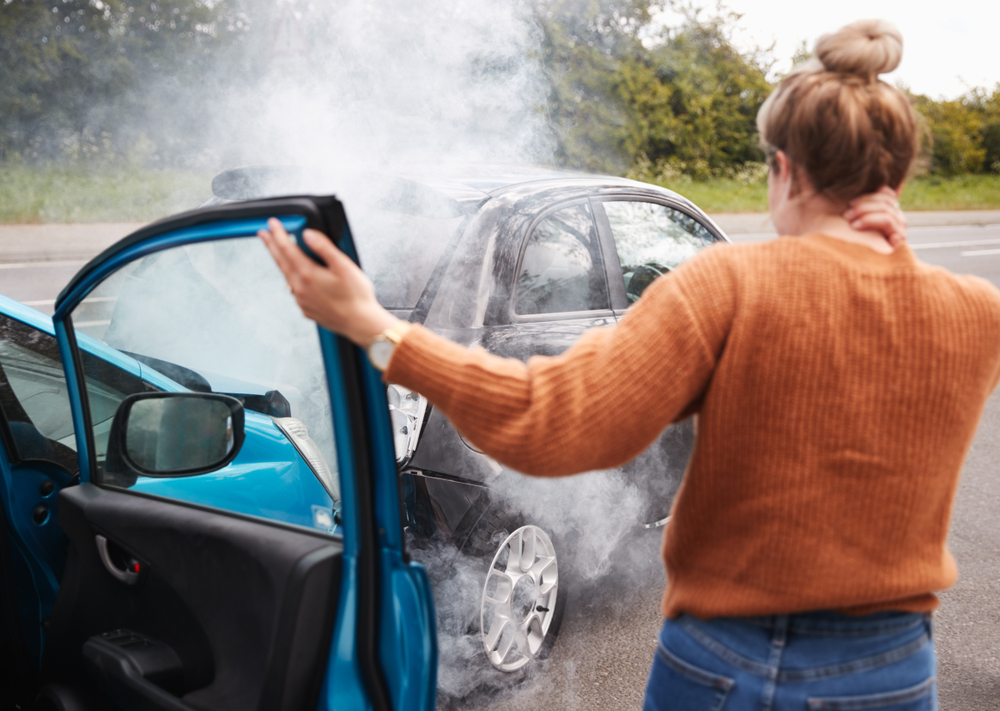 woman standing outside of car after collision