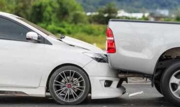 car rear ending truck on road