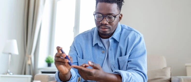 diabetic man poking finger
