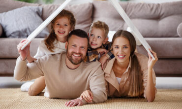 family of four smiling at camera