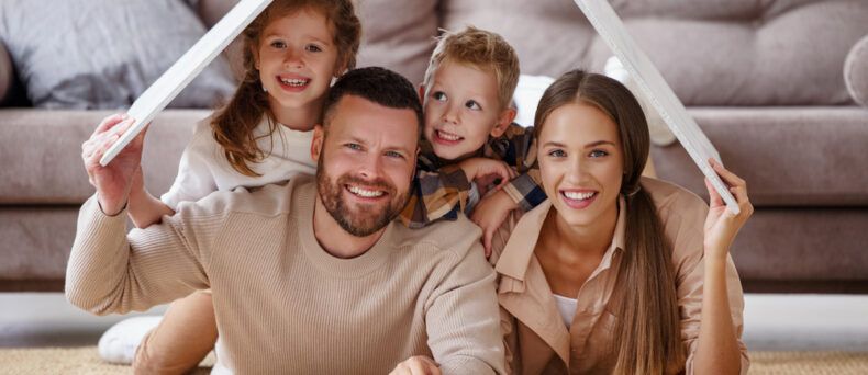 family of four smiling at camera