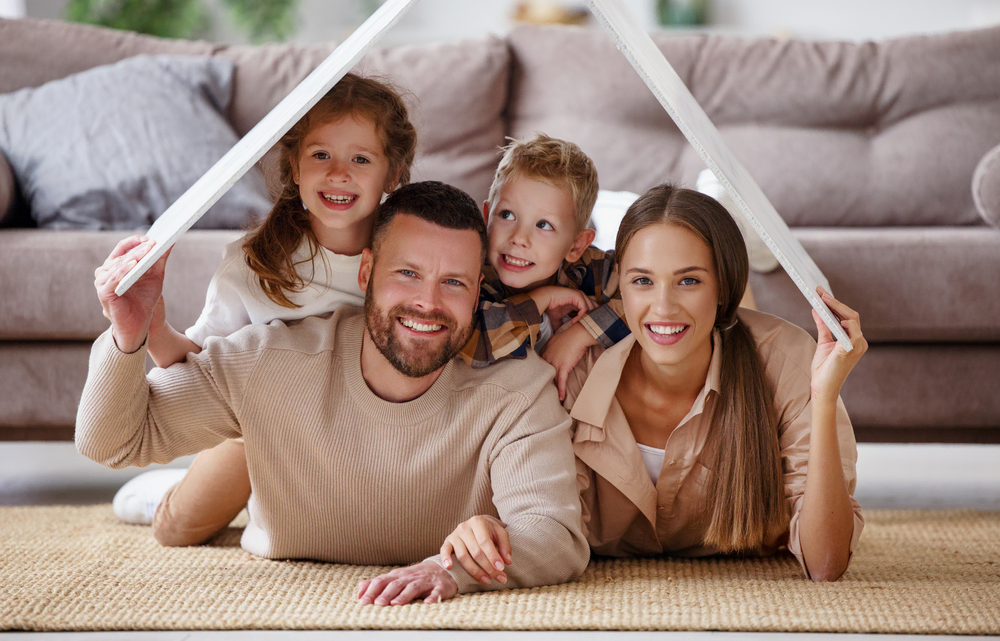 family of four smiling at camera