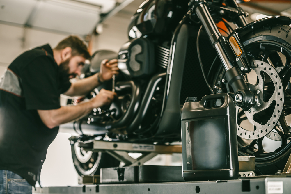 man inspecting his motorcycle