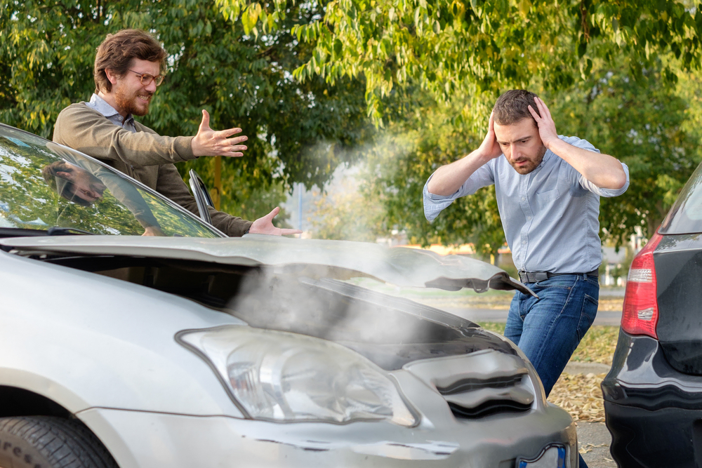 two people near cars in accident