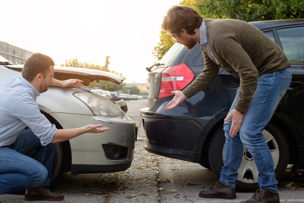 people standing near car collision