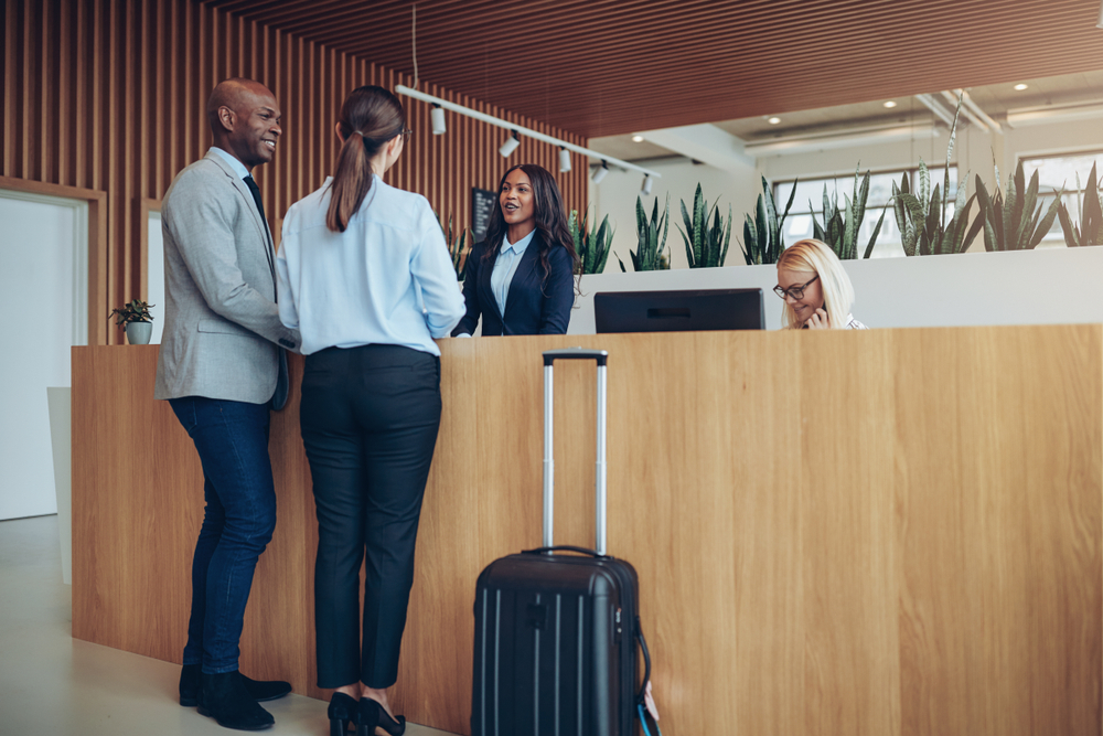 couple checking into hotel at front desk