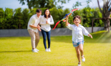 family running in yard