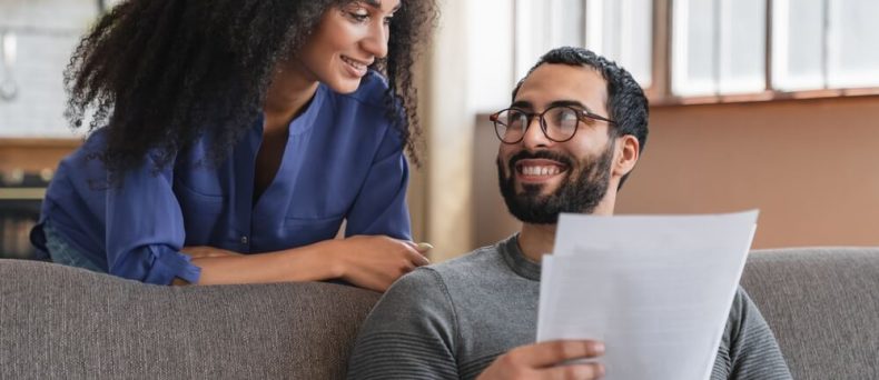 Couple reviewing paperwork at home, emphasizing why Atlanta renters need insurance for financial protection.