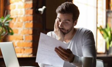 person sitting at desk reviewing paperwork