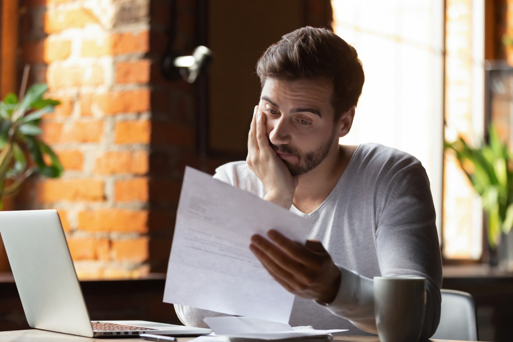 person sitting at desk reviewing paperwork