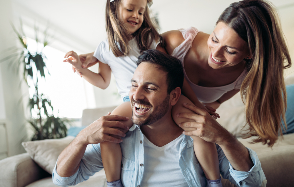 family of three laughing