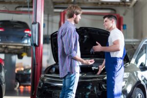 Mechanic explains repairs to unhappy customer