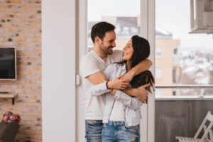 Young couple celebrates getting renters insurance in their new apartment in Georgia
