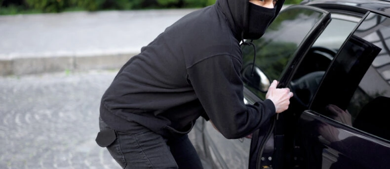 thief stealing a car