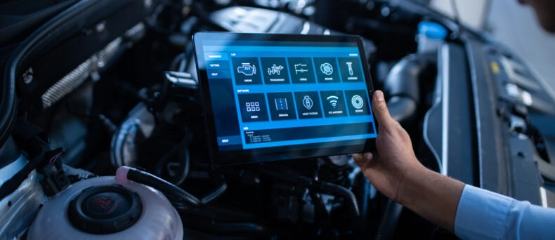 Mechanic uses computer to diagnose car maintenance costs in Georgia