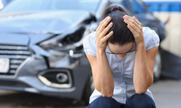 Woman holds her heard after an accident