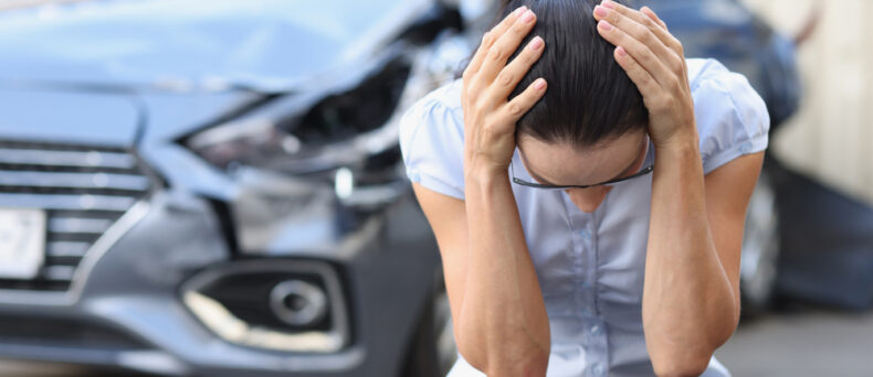 Woman holds her heard after an accident