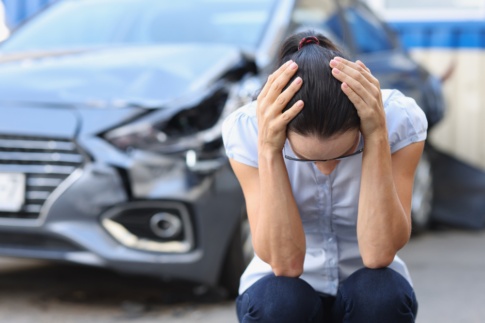 Woman holds her heard after an accident