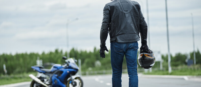 Biker walks back to his motorcycle to start motorcycle ride in Savannah