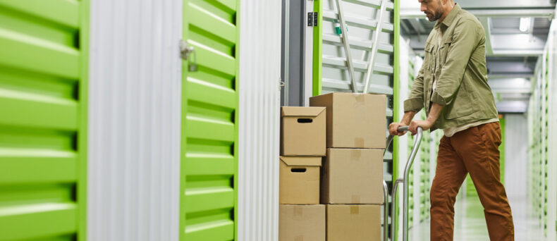 Man puts stuff into a storage unit