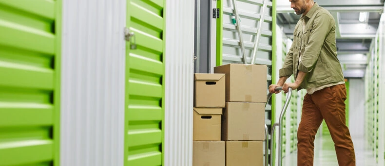 Man puts stuff into a storage unit