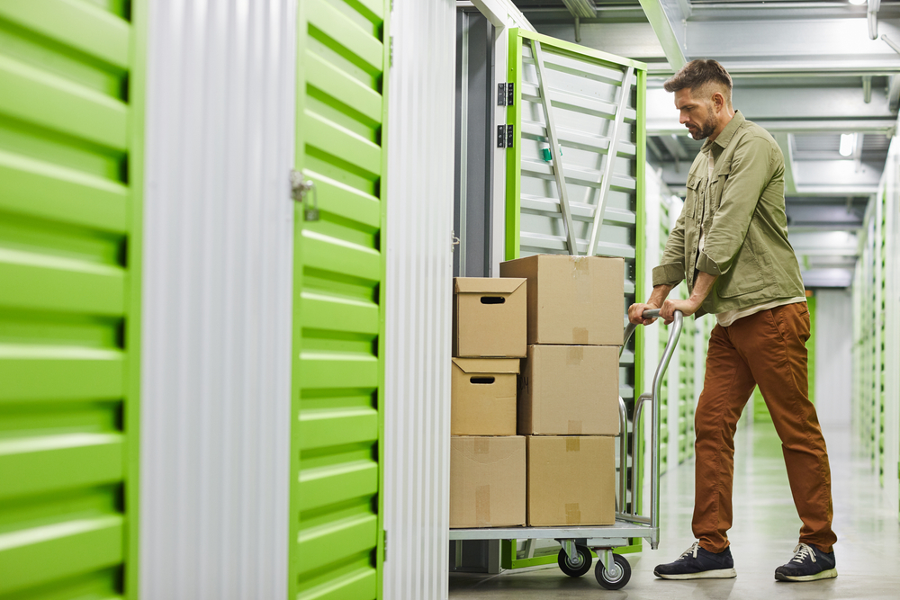 Man puts stuff into a storage unit