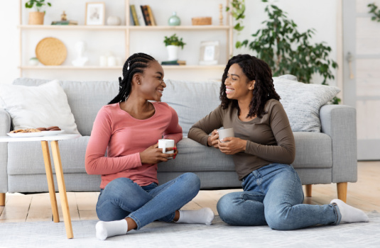 Roommates sit on the floor in their shared Atlanta apartment