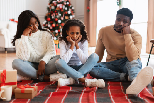Husband, wife and child with sad faces after holiday presents are ruined - renters insurance in Georgia