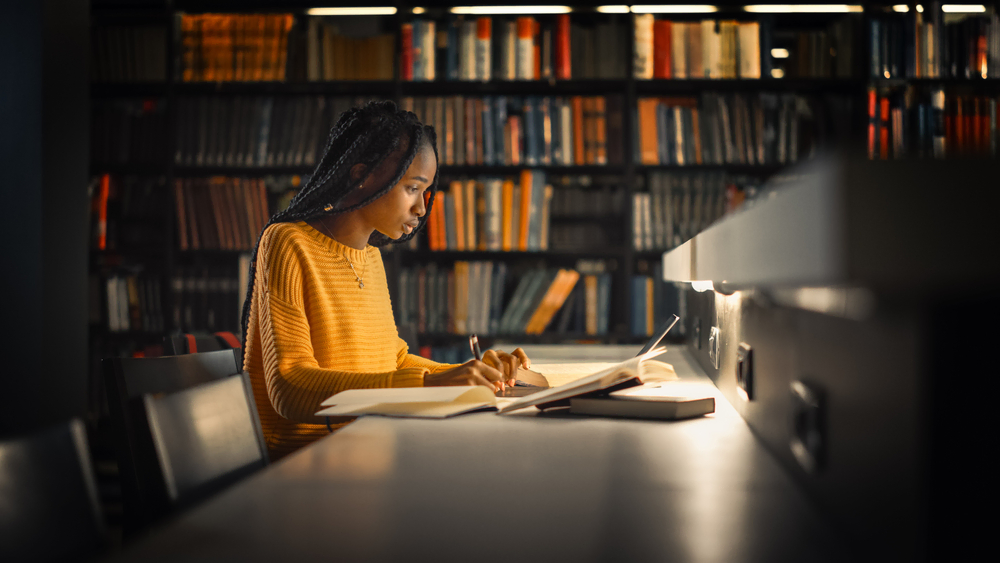 Young African-American girl studys in the college library - cheap renters insurance in Georgia