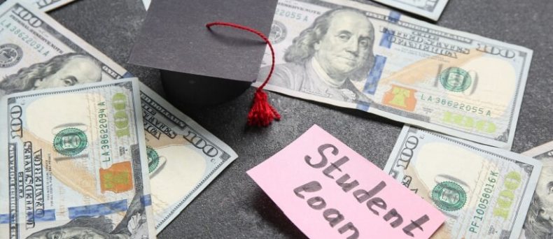 Graduation cap, U.S. dollar bills, and a note reading student loan, illustrating the financial reality of student loans in Georgia.