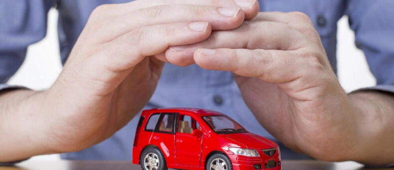 Image of hands making a shelter over a new car, Gap insurance.